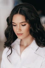 Portrait of beautiful young brunette girl with makeup