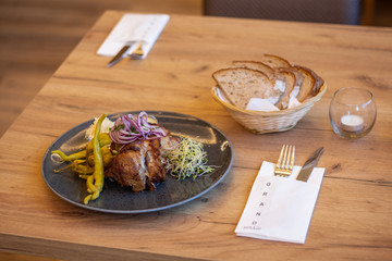 a half-pound slow-roasted boneless pork knee with horseradish, mustard, goat horn, and bread