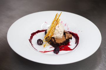 chocolate brownies with ice cream walnut oil and a coulis of forest fruit