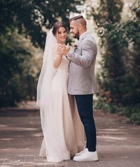 Bride and Groom at wedding Day walking Outdoors on spring nature. Bridal couple,  Loving wedding couple outdoor. 