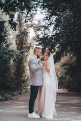 Bride and Groom at wedding Day walking Outdoors on spring nature. Bridal couple,  Loving wedding couple outdoor. 