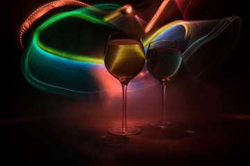 Goblet of white wine on wooden table on wooden wall background