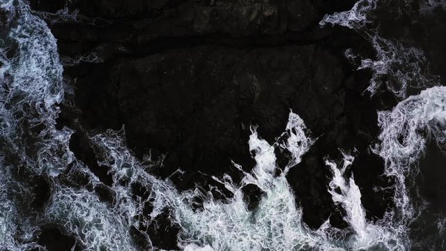 Top down view of giant ocean waves crashing and foaming