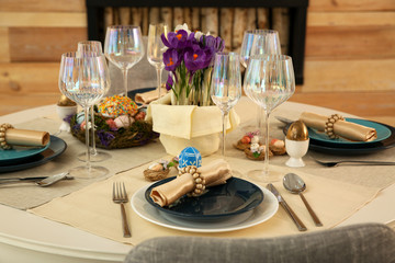 Festive Easter table setting with decorated eggs in kitchen