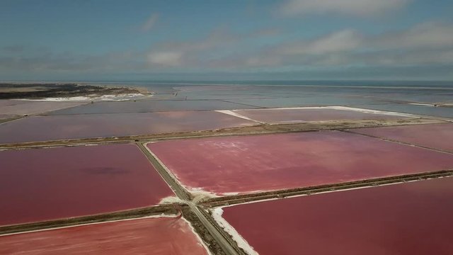 4K aerial drone video of salt works factory wide pink salty water evaporation ponds, in outskirts of coastal harbour town Walvis Bay, Namib Desert, Atlantic Ocean west coast, Namibia, southern Africa