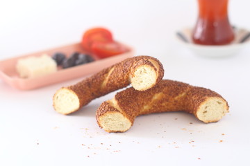 Turkish bagel, simit, tomatoes & Turkish tea on white background. 