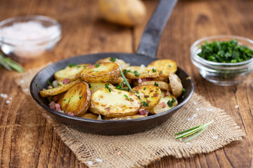 Fried Potatoes on a wooden table (selective focus)
