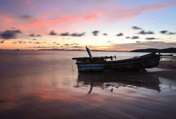 Sunset and abandoned boat