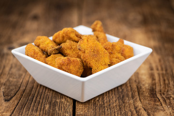 Vintage wooden table with fresh made Chicken Nuggets