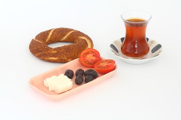 Turkish bagel, simit, tomatoes & Turkish tea on white background. 