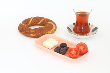 Turkish bagel, simit, tomatoes & Turkish tea on white background. 