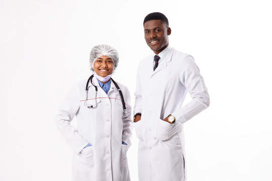 Two doctors on a white background. Indian woman with a phonendoscope.African man.