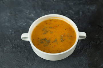 The Tarhana soup on the black background with sauces from Turkey.