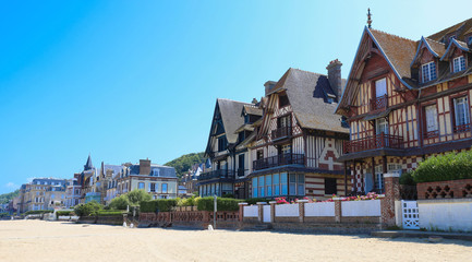 The h omes on Deauville beach in Normandy - France. - obrazy, fototapety, plakaty