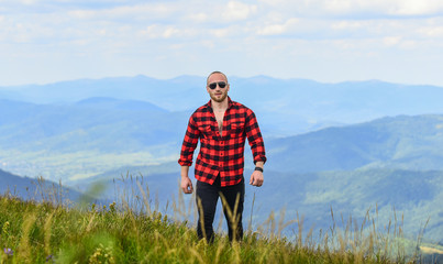 mountain king. man on mountain landscape. camping and hiking. cowboy in hat outdoor. sexy macho man in checkered shirt. travelling adventure. hipster fashion. countryside concept. farmer on rancho