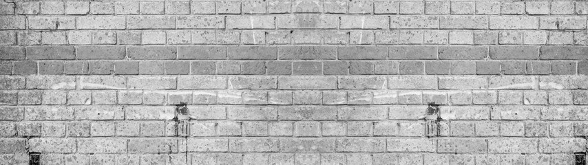 White gray painted damaged rustic brick wall texture banner panorama	