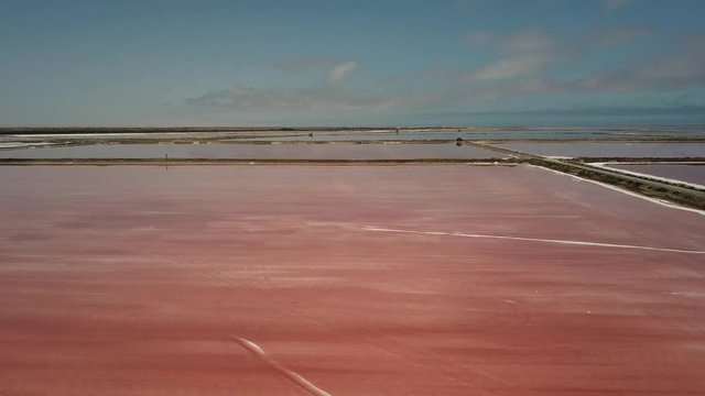 4K aerial drone video of salt works factory wide pink salty water evaporation ponds, in outskirts of coastal harbour town Walvis Bay, Namib Desert, Atlantic Ocean west coast, Namibia, southern Africa