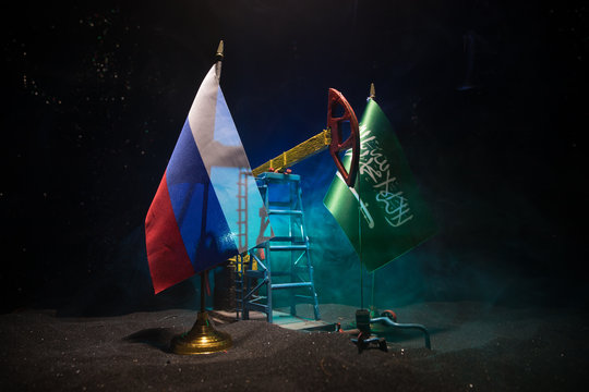 Business dialogue, oil agreement concept: National flags with Oil pump and oil refining factory at night with fog and backlight. Energy industrial concept.