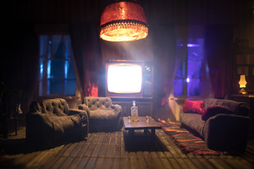 A realistic dollhouse living room with furniture and window at night. Artwork table decoration with handmade realistic dollhouse.