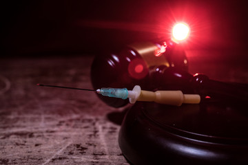 Prisoner handcuffed to death by lethal injection, vial with sodium thiopental and syringe on top of...