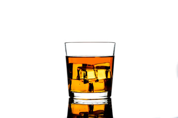 Whiskey with ice cubes.Isolated shot of whiskey.Glass of scotch and ice cubes on a white background.