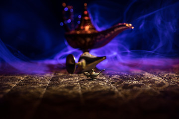 Lamp of wishes concept. Antique Aladdin arabian nights genie style oil lamp with soft light white...