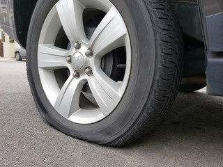 Obraz premium Flat tire in parking lot of apartment building.