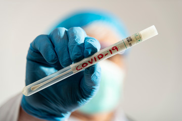 doctor showing a medical laboratory swab for coronavirus detection