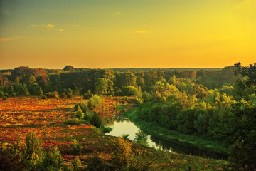 beautiful landscape dawn with clouds overlooking a forest field and a river