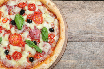 Delicious pizza Diablo on wooden table, top view