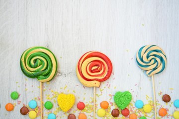 colorful lollipop on wooden background