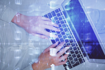 Double exposure of woman hands working on computer and data theme hologram drawing. Top View. Technology concept.