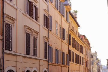 Facades of Roman streets. Narrow street rising up. Street in the Central part of the historic center.