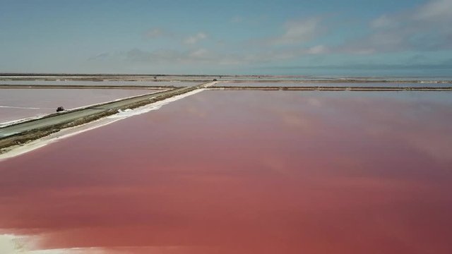 4K aerial drone video of salt works factory wide pink salty water evaporation ponds, in outskirts of coastal harbour town Walvis Bay, Namib Desert, Atlantic Ocean west coast, Namibia, southern Africa