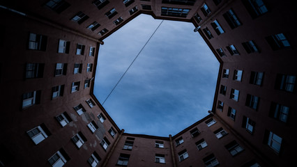 View of the blue sky from the depths of the courtyard