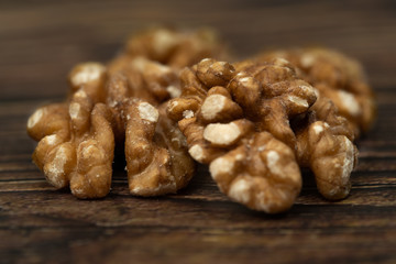 halves of walnuts on a wooden background