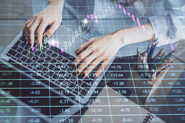 Double exposure of woman hands typing on computer and forex chart hologram drawing. Stock market invest concept.
