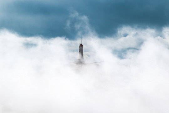 View of lighthouse covered with clouds