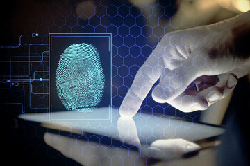 Double exposure of man's hands holding and using a digital device and fingerprint hologram drawing....