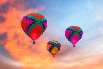 Three colorful hot air balloons against a sunset sky in Arizona.