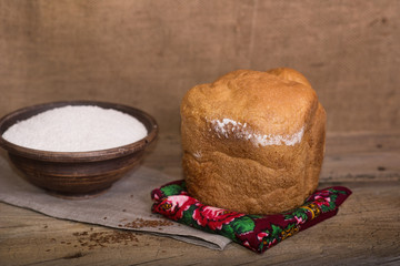 Fototapeta na wymiar Village freshly baked bread on a table with eggs and flour
