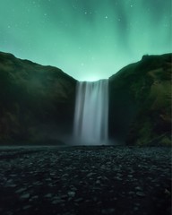 Northern Lights at Skogafoss waterfall in Iceland