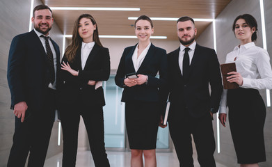 Successful coworkers standing in corridor
