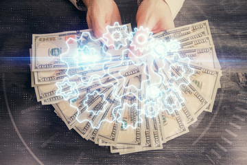 Multi exposure of financial theme drawing hologram and USA dollars bills and man hands. Business concept.