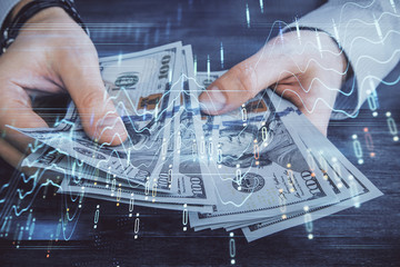 Multi exposure of financial graph drawing hologram and USA dollars bills and man hands. Analysis concept.