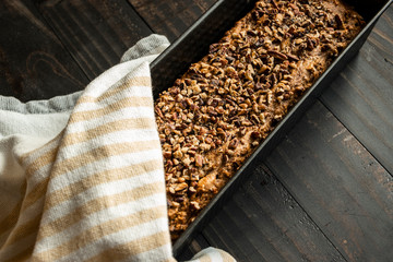Fresh Banana Bread Loaf in Pan with Towel