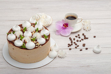 Delicious brown cake with marshmallows and a cup of coffee