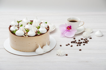 Delicious brown cake with marshmallows and a cup of coffee