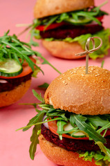 Veggie beet and lentil burgers with vegetables and avocado sauce. Healthy food concept.