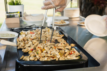 grilled chicken fajitas, prepared outdoors on a chrome table